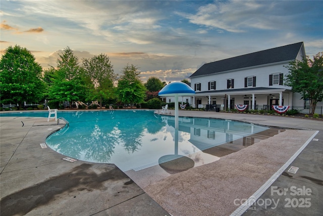 3426 Richards Xing, Fort Mill, SC 29708 - pool at dusk with a patio area, a community pool, and fence