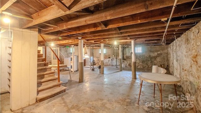 basement featuring stairs and water heater