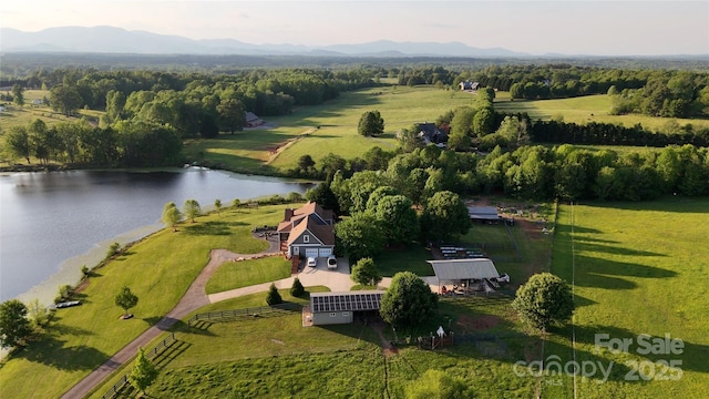 aerial view of property's location with a nearby body of water and rural landscape