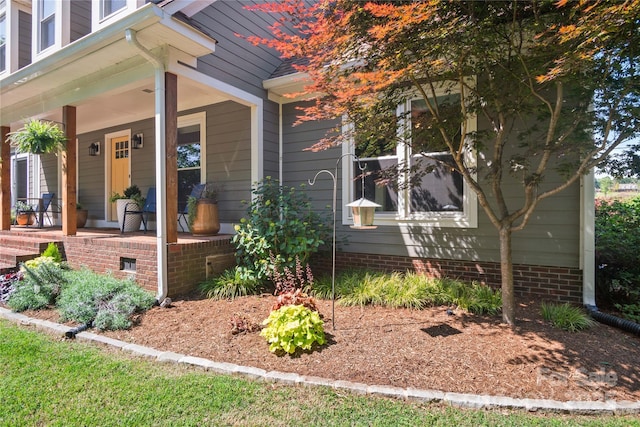 view of property exterior with covered porch