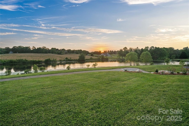 view of grassy yard with a water view