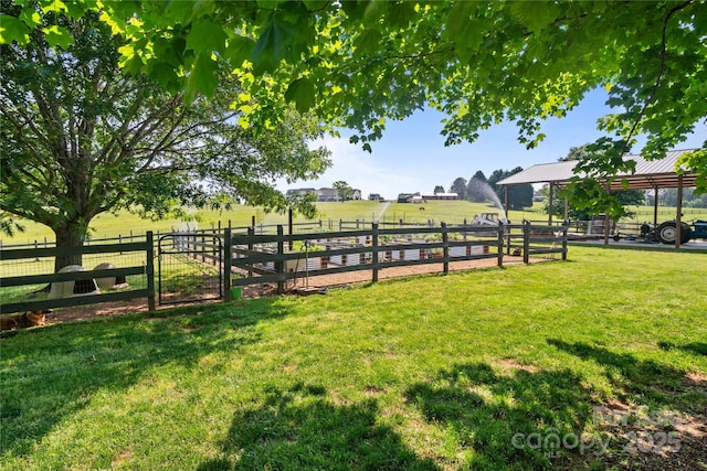 view of yard featuring a gate and a view of rural / pastoral area