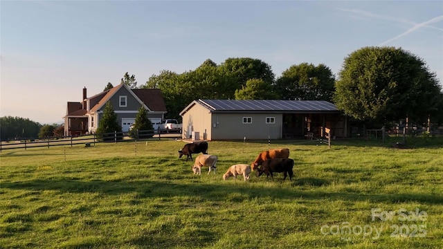 view of yard with an exterior structure, an outbuilding, and a rural view