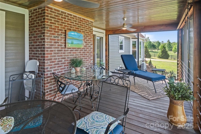 wooden deck with a ceiling fan and outdoor dining area
