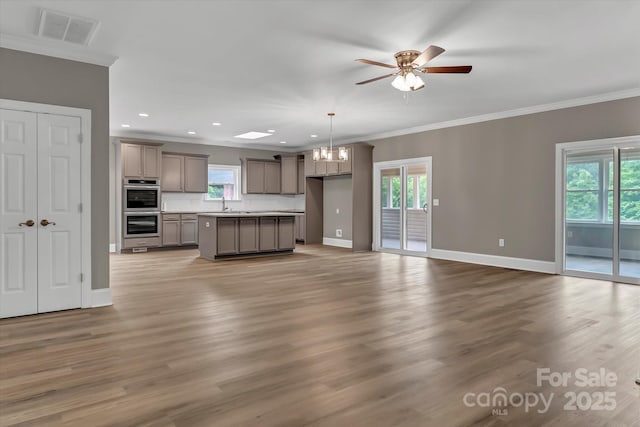 332 E Rebound Rd, Lancaster, SC 29720 - unfurnished living room featuring a sink, ornamental molding, a ceiling fan, baseboards, and a chandelier