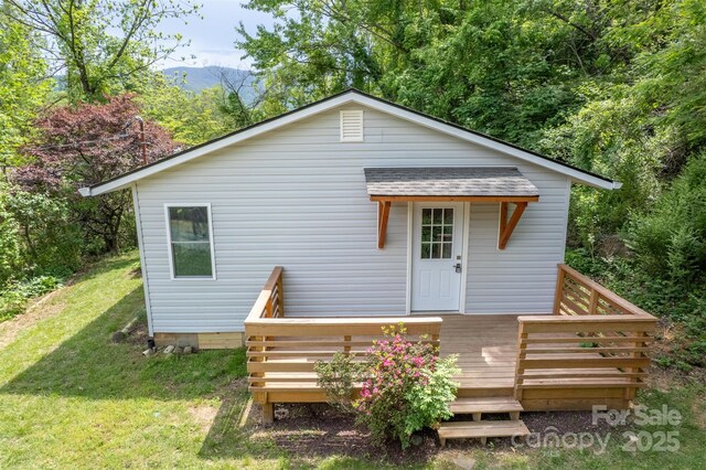307 Hawthorne Ave, Swannanoa, NC 28778 - rear view of property featuring a yard, a deck, and roof with shingles