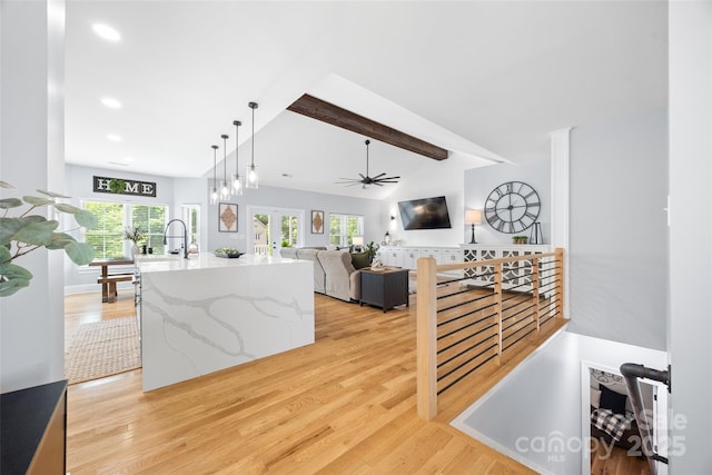 184 Quiet Cove Rd, Mooresville, NC 28117 - kitchen with light wood-style flooring, ceiling fan, recessed lighting, decorative light fixtures, and light stone countertops