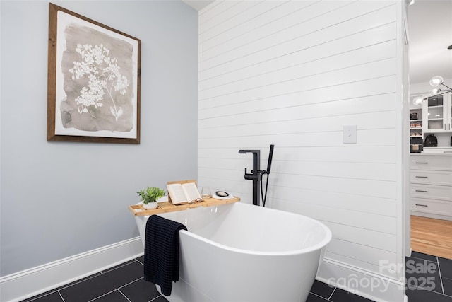 184 Quiet Cove Rd, Mooresville, NC 28117 - bathroom featuring tile patterned floors, a freestanding tub, and baseboards