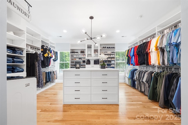 184 Quiet Cove Rd, Mooresville, NC 28117 - spacious closet with light wood-type flooring and a chandelier