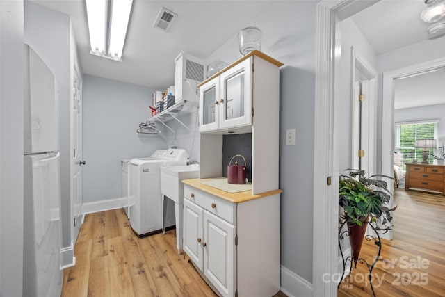 184 Quiet Cove Rd, Mooresville, NC 28117 - clothes washing area with independent washer and dryer, light wood-style floors, and baseboards