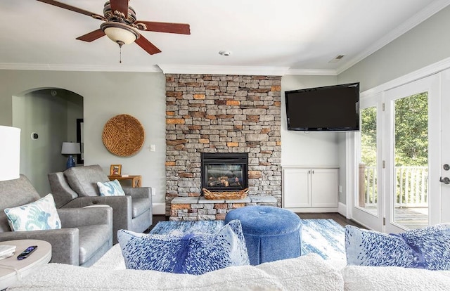 46827 Tall Whit Rd, New London, NC 28127 - living room with wood finished floors, a ceiling fan, a fireplace, visible vents, and ornamental molding