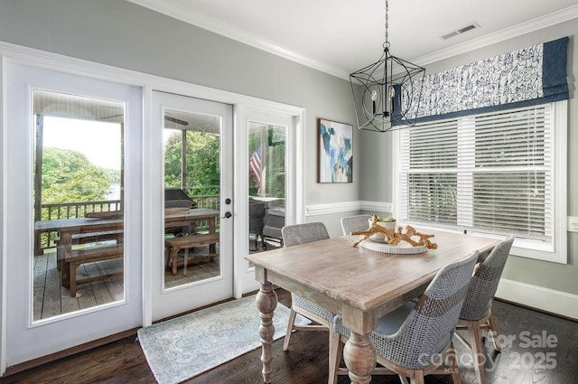 46827 Tall Whit Rd, New London, NC 28127 - dining area featuring crown molding, a chandelier, visible vents, and dark wood-type flooring