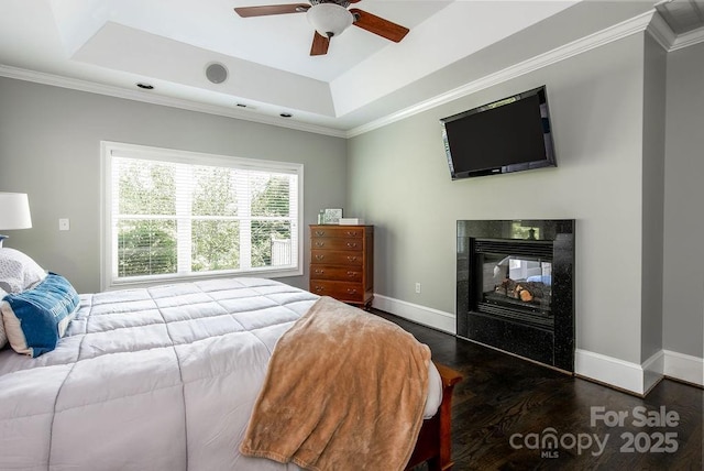 46827 Tall Whit Rd, New London, NC 28127 - bedroom with wood finished floors, a fireplace, crown molding, a tray ceiling, and baseboards