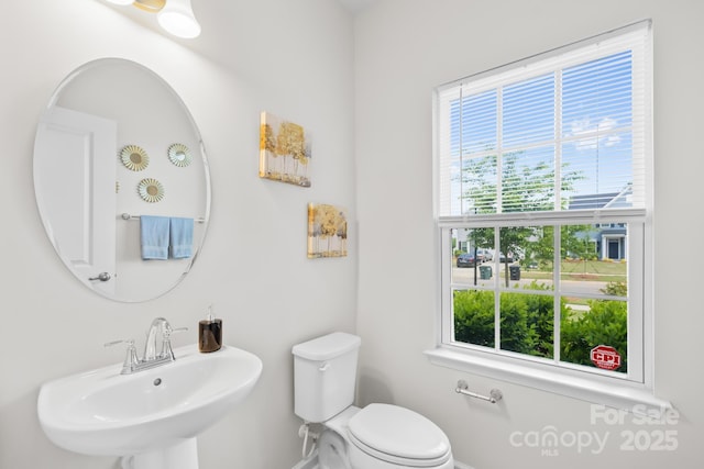 2012 Slippery Rock Ln, Monroe, NC 28112 - bathroom featuring a sink, plenty of natural light, toilet, and baseboards