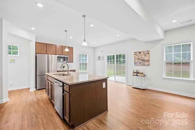 2012 Slippery Rock Ln, Monroe, NC 28112 - kitchen with stainless steel appliances, a sink, light wood-type flooring, plenty of natural light, and recessed lighting