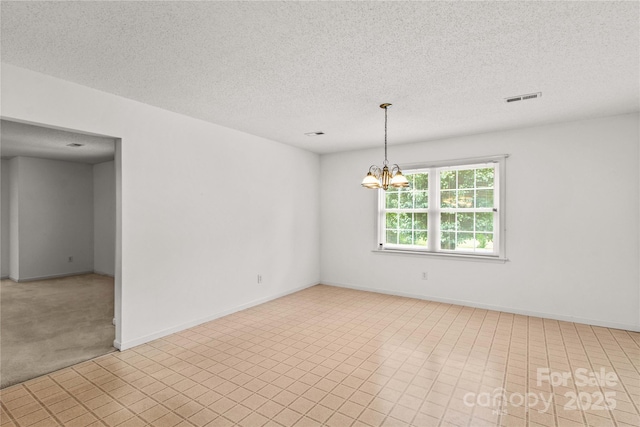 115 Three Oaks Ln, Statesville, NC 28677 - spare room featuring a textured ceiling, a chandelier, and baseboards