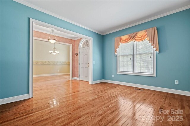 600 Robinhood Dr, Cheraw, SC 29520 - unfurnished room featuring baseboards, ornamental molding, visible vents, a chandelier, and hardwood / wood-style floors