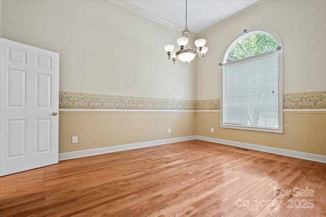600 Robinhood Dr, Cheraw, SC 29520 - spare room with ornamental molding, a notable chandelier, baseboards, and wood finished floors