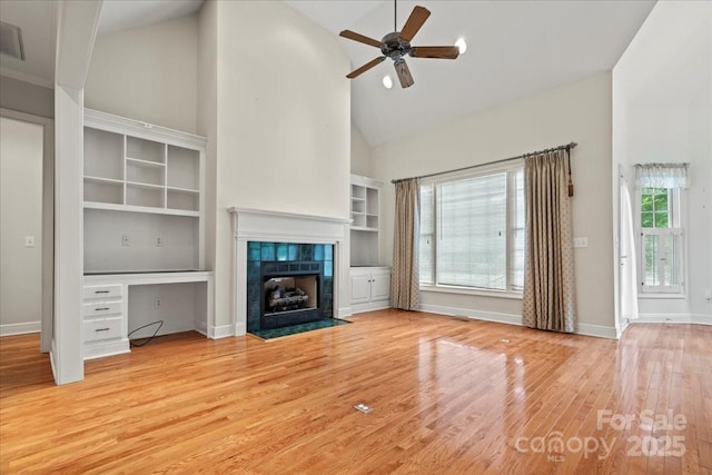 600 Robinhood Dr, Cheraw, SC 29520 - unfurnished living room with a ceiling fan, high vaulted ceiling, a fireplace, baseboards, and light wood-style floors