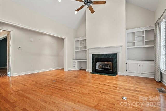 600 Robinhood Dr, Cheraw, SC 29520 - unfurnished living room with light wood finished floors, high vaulted ceiling, visible vents, ceiling fan, and a high end fireplace
