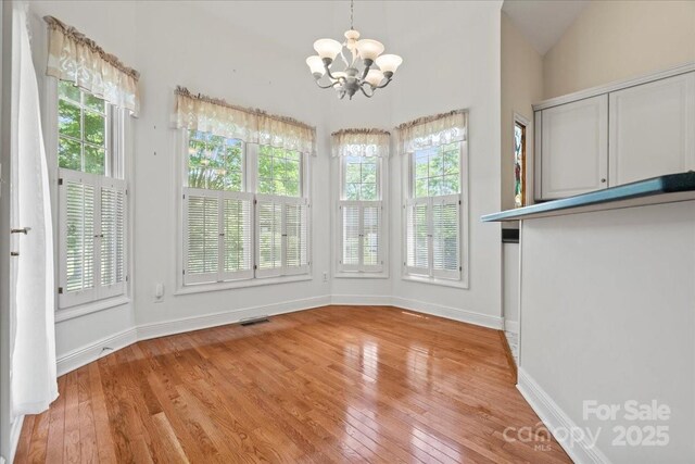 600 Robinhood Dr, Cheraw, SC 29520 - interior space featuring baseboards, a wealth of natural light, a notable chandelier, and light wood-type flooring