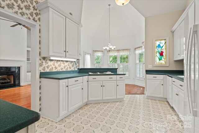 600 Robinhood Dr, Cheraw, SC 29520 - kitchen featuring a fireplace, dark countertops, and white cabinets