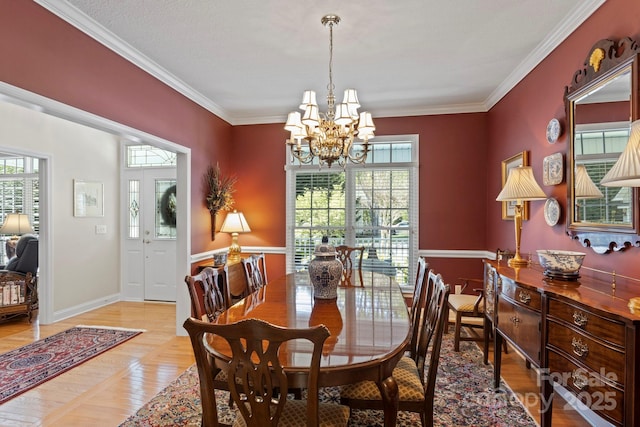 216 Cold Stream Way, Hendersonville, NC 28791 - dining area with ornamental molding, a chandelier, and a healthy amount of sunlight