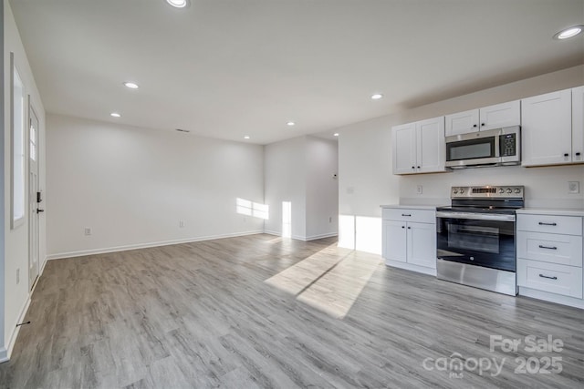 1265 Margaret St NW, Valdese, NC 28690 - kitchen with light countertops, light wood finished floors, open floor plan, and appliances with stainless steel finishes