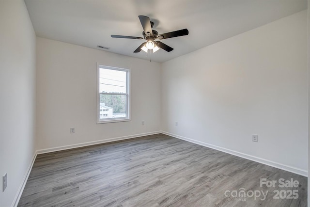 1265 Margaret St NW, Valdese, NC 28690 - spare room featuring baseboards, visible vents, wood finished floors, and a ceiling fan