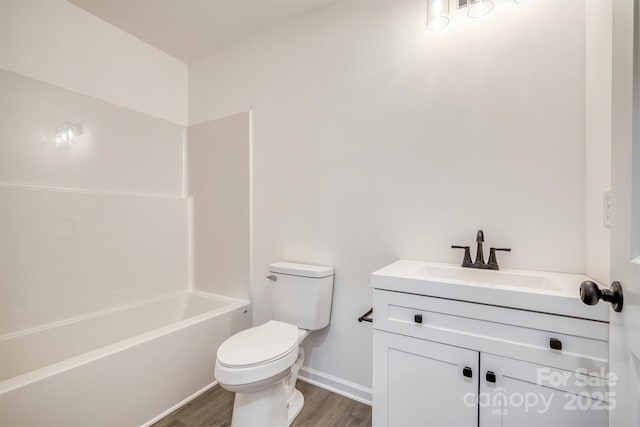1265 Margaret St NW, Valdese, NC 28690 - full bathroom featuring toilet, wood finished floors, baseboards, vanity, and shower / bathtub combination