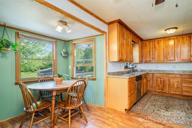 kitchen featuring stainless steel dishwasher, a sink, light wood-type flooring, crown molding, and brown cabinetry