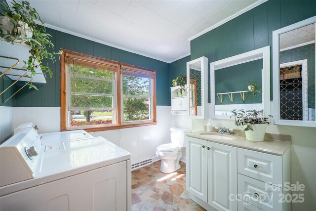bathroom with washer and dryer, crown molding, toilet, and vanity