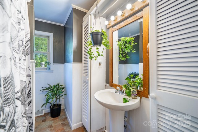 full bathroom featuring crown molding and stone finish flooring
