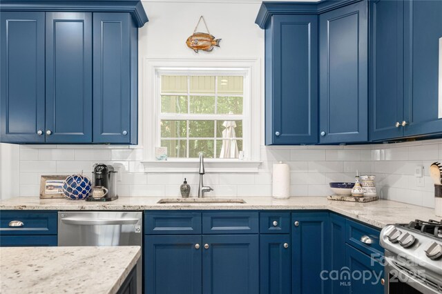 kitchen featuring a sink, blue cabinetry, and decorative backsplash