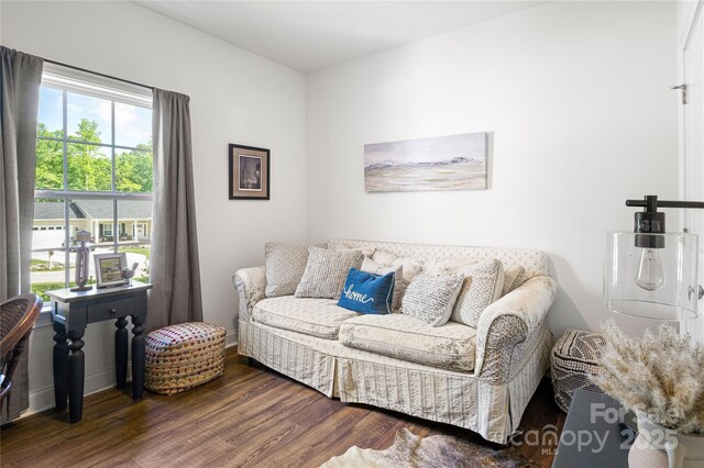 living area featuring wood finished floors and baseboards