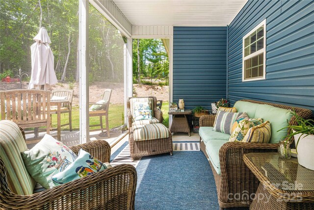 sunroom featuring an outdoor living space