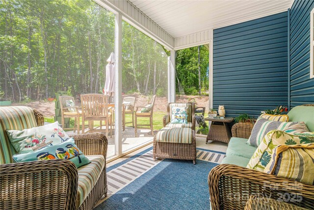 sunroom / solarium with outdoor lounge area and outdoor dining space