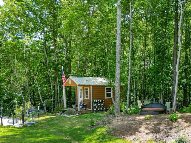 view of outbuilding featuring an outbuilding and a forest view