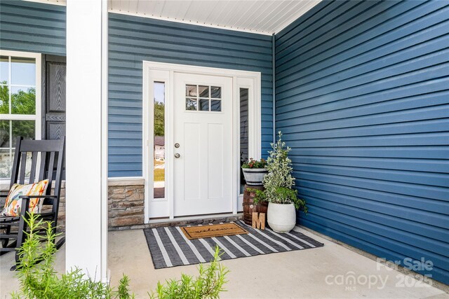 property entrance featuring stone siding
