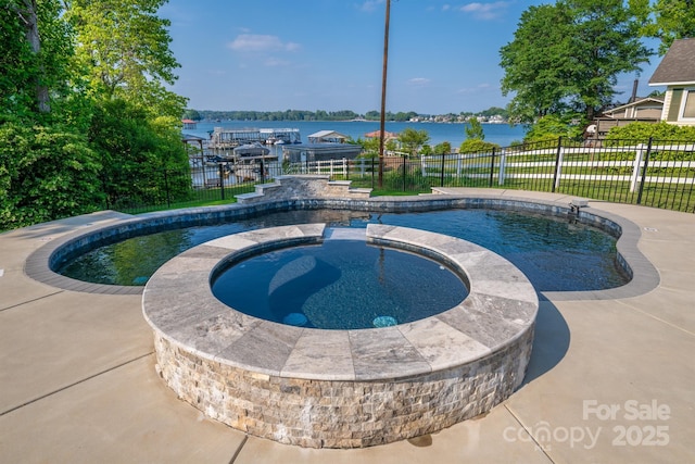 view of swimming pool featuring an in ground hot tub, fence, and a fenced in pool