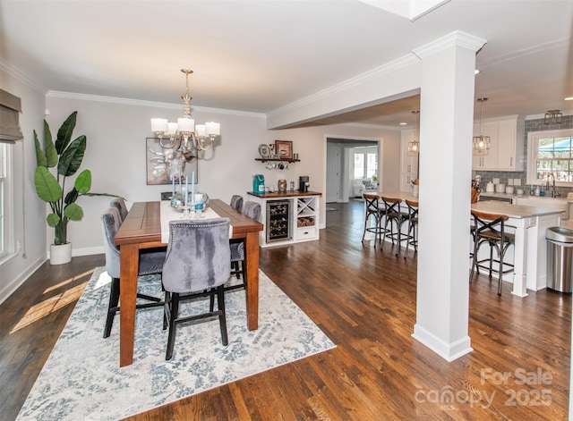 dining room featuring an inviting chandelier, ornamental molding, and dark wood-style floors