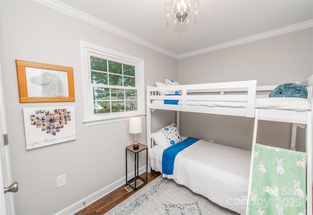 bedroom featuring crown molding, wood finished floors, and baseboards