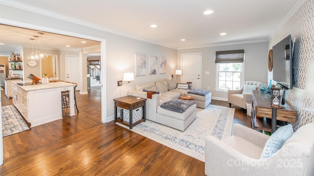 living room featuring ornamental molding, dark wood-style floors, and recessed lighting
