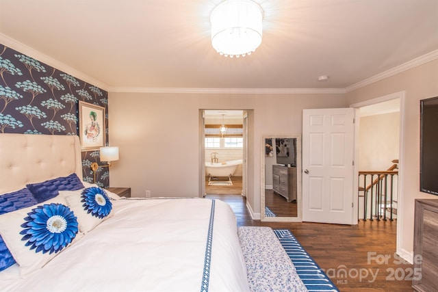 bedroom with ensuite bathroom, wood finished floors, crown molding, an inviting chandelier, and baseboards