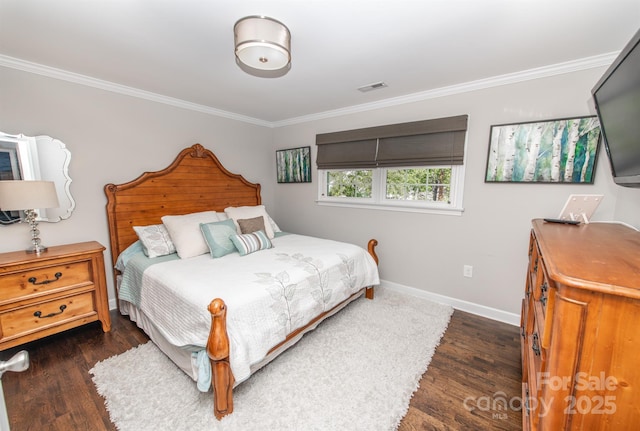 bedroom with visible vents, wood finished floors, baseboards, and ornamental molding