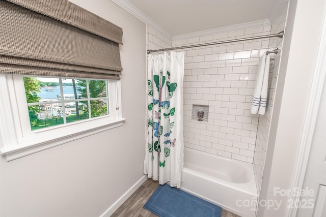 bathroom featuring shower / bath combo with shower curtain, wood finished floors, crown molding, a water view, and baseboards