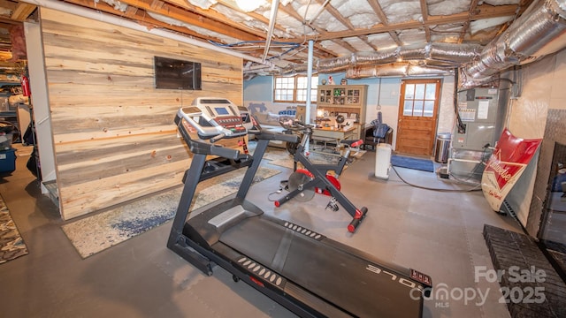 workout area with wood walls and heating unit