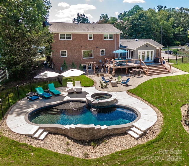 view of swimming pool with an outdoor fire pit, a patio area, a deck, and a fenced backyard