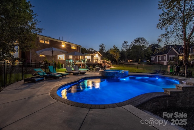 view of swimming pool featuring a patio, a pool with connected hot tub, a wooden deck, a fenced backyard, and stairs