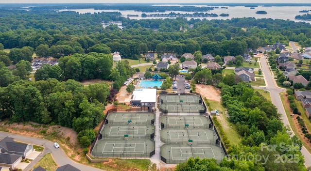 birds eye view of property featuring a forest view and a residential view